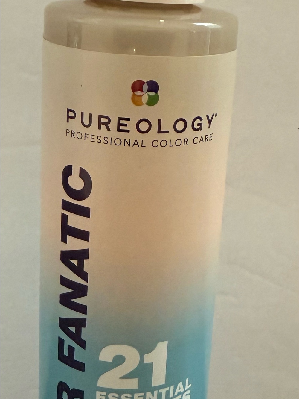 Pureology spray bottle in white and blue with multicolor logo